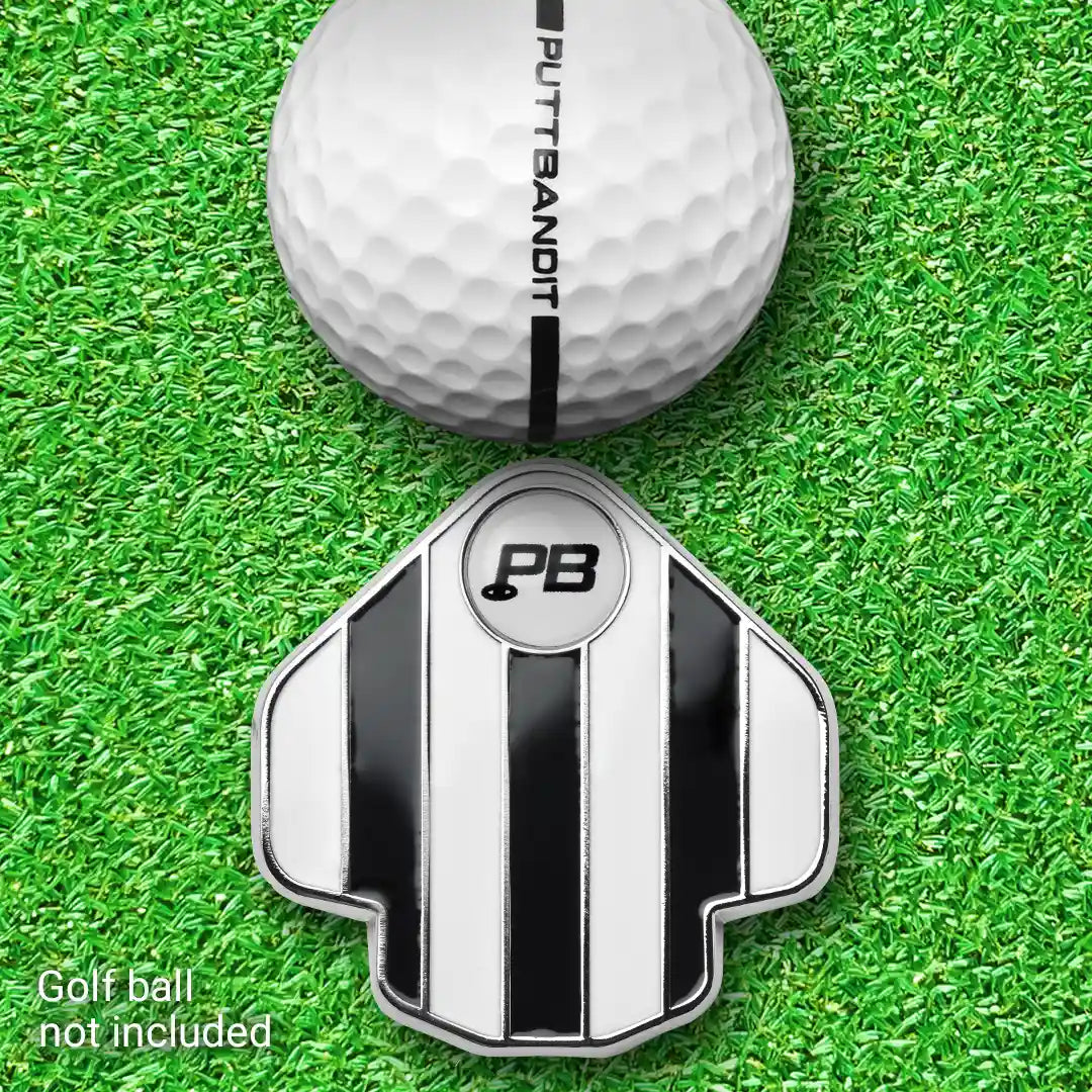 PuttBANDIT LP black golf ball marker top view with golf ball on grass, ball not included text